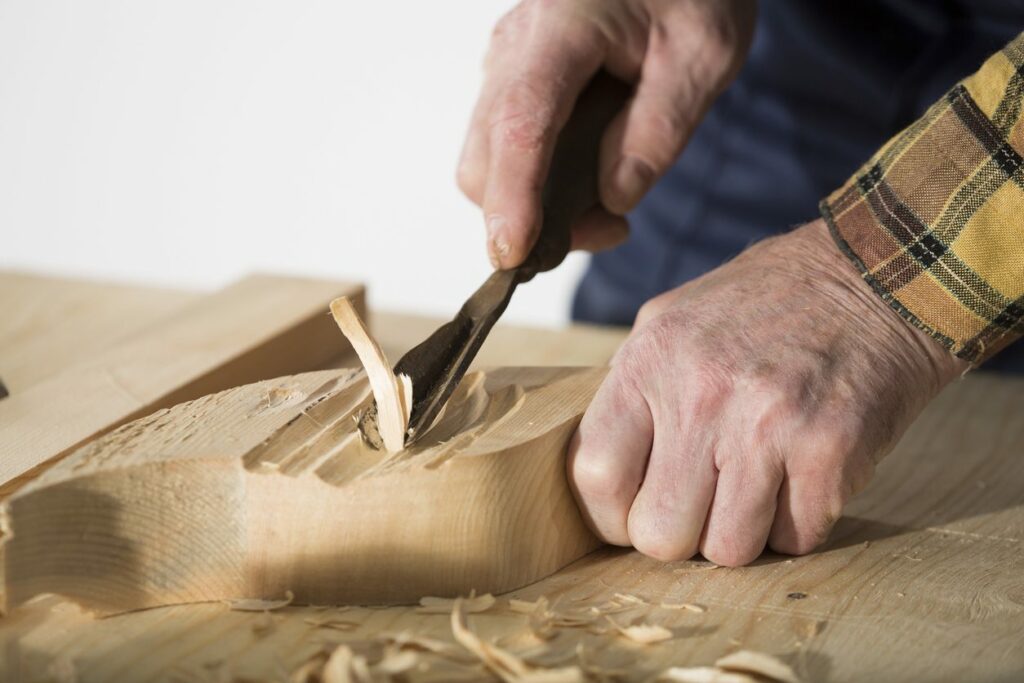 Old woodcarver work in the workshop