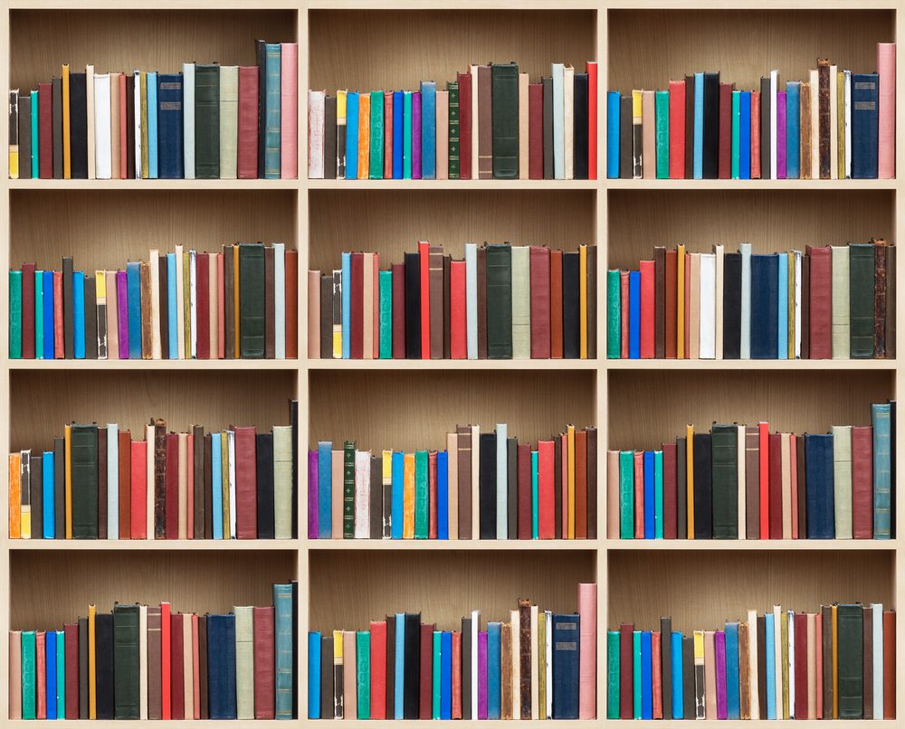 Books on a wooden shelfs.