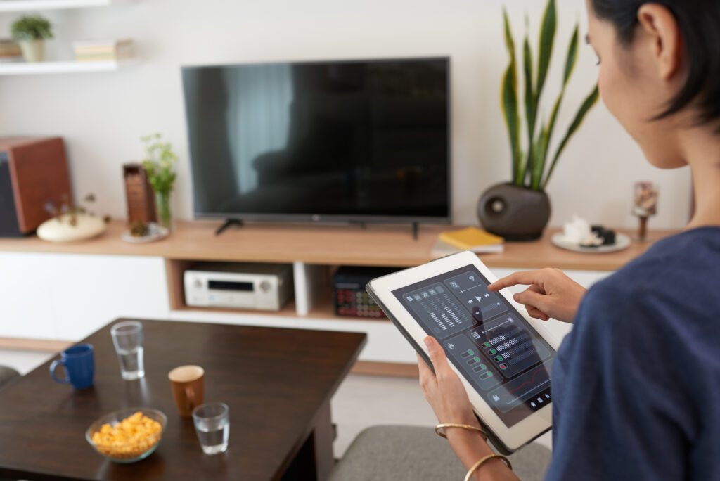 Young woman using application in his smart home